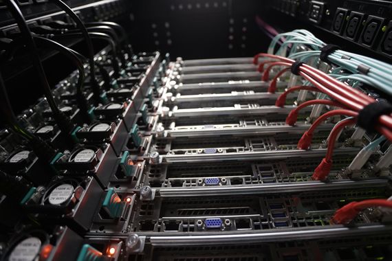 Server rack with multiple servers, cables, and connections.