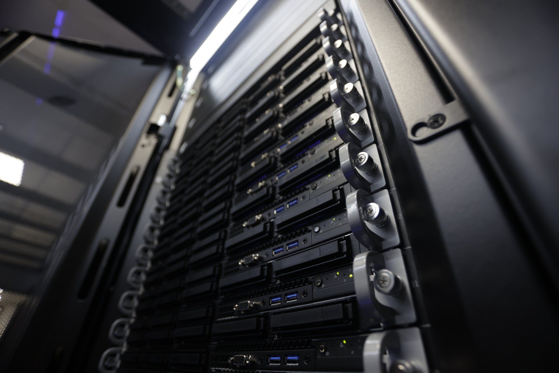 Server rack filled with computer hardware in a data center.