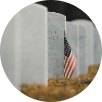 American flag beside white gravestones in a cemetery