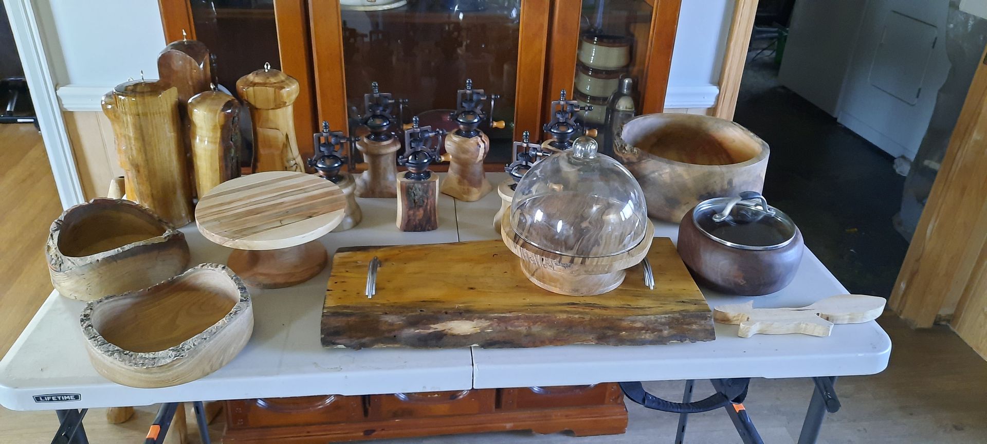Wooden bottle stoppers on display, various shapes and wood grains, arranged on a blue cloth.
