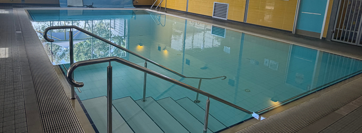 A swimming pool with a red banner that reads 