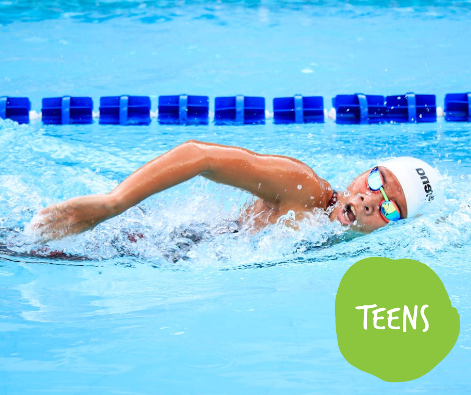 Swimmer in cap and goggles swims breaststroke in a pool with lane markers.