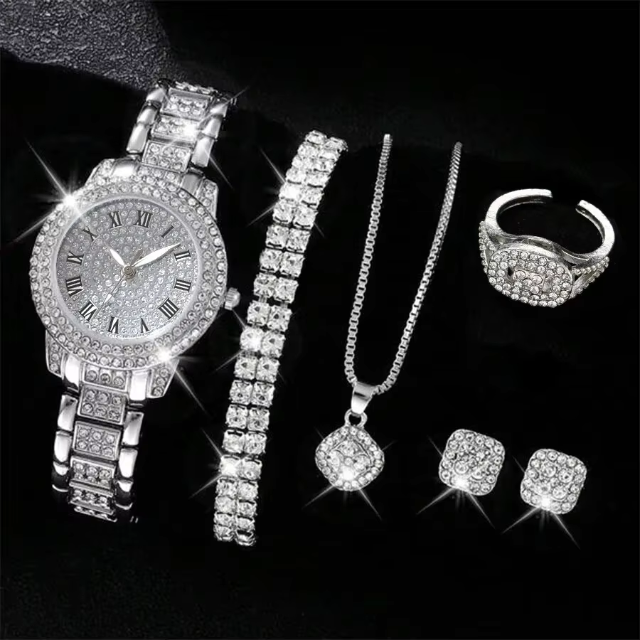 Silver diamond jewelry set with watch, bracelet, necklace, ring, and earrings on black background