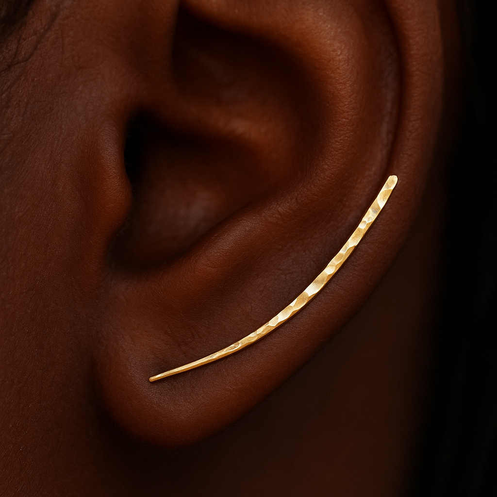 Close-up of an ear with a thin gold hoop earring