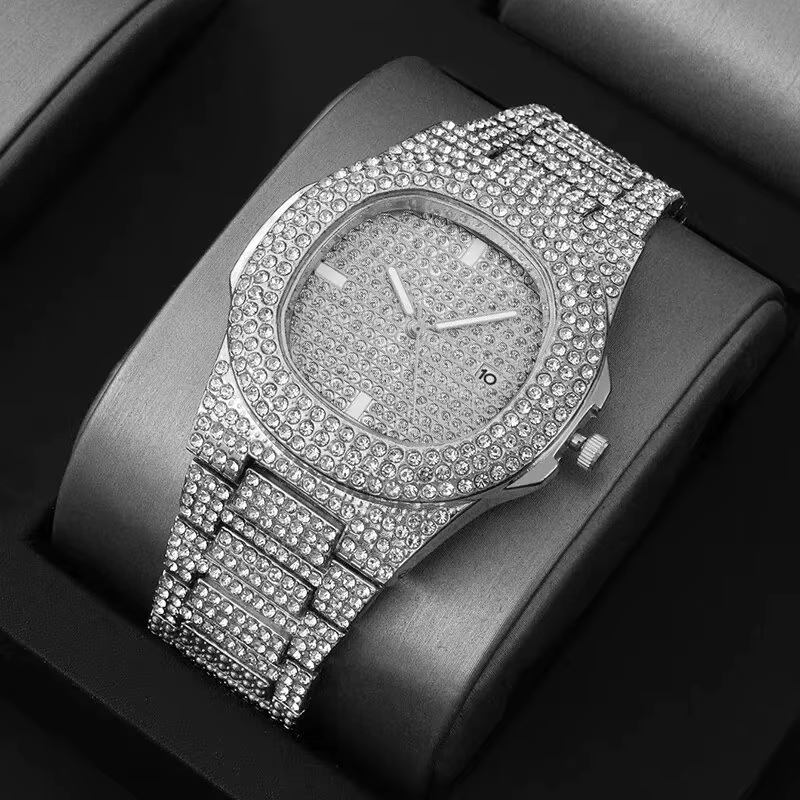Diamond-studded silver wristwatch on a black display cushion
