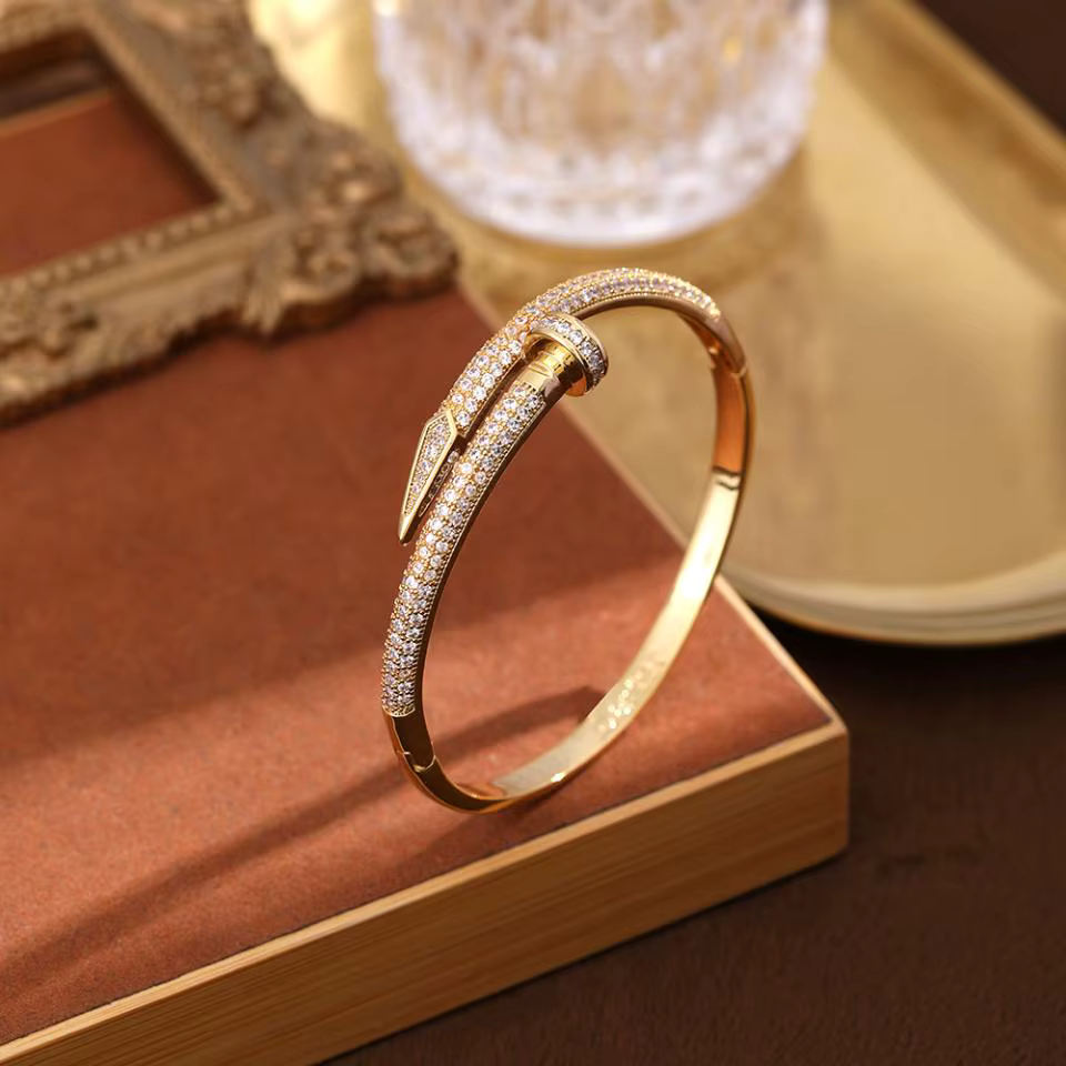Silver diamond bracelet on a brown book with a decorative frame in the background