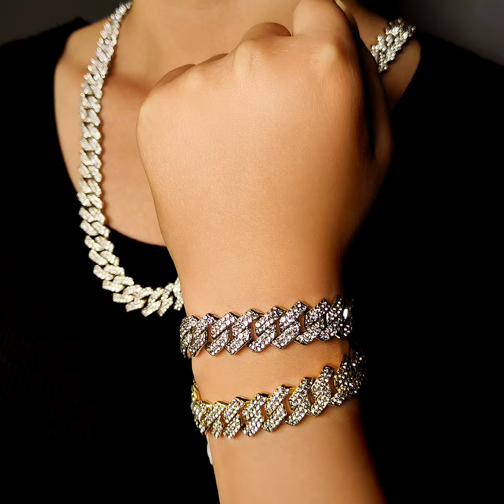 Diamond necklaces and bracelets displayed on a hand against a black background