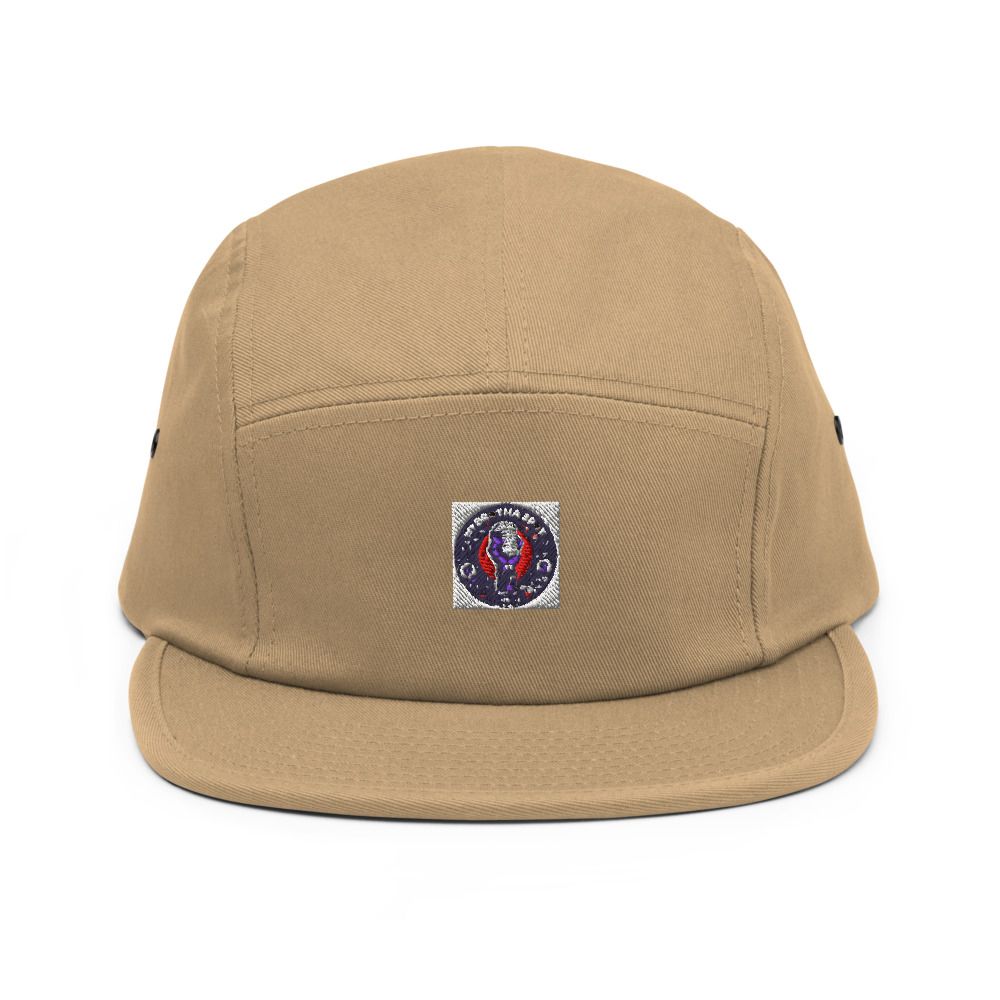 Tan baseball cap with a small embroidered patch on the front and a flat brim