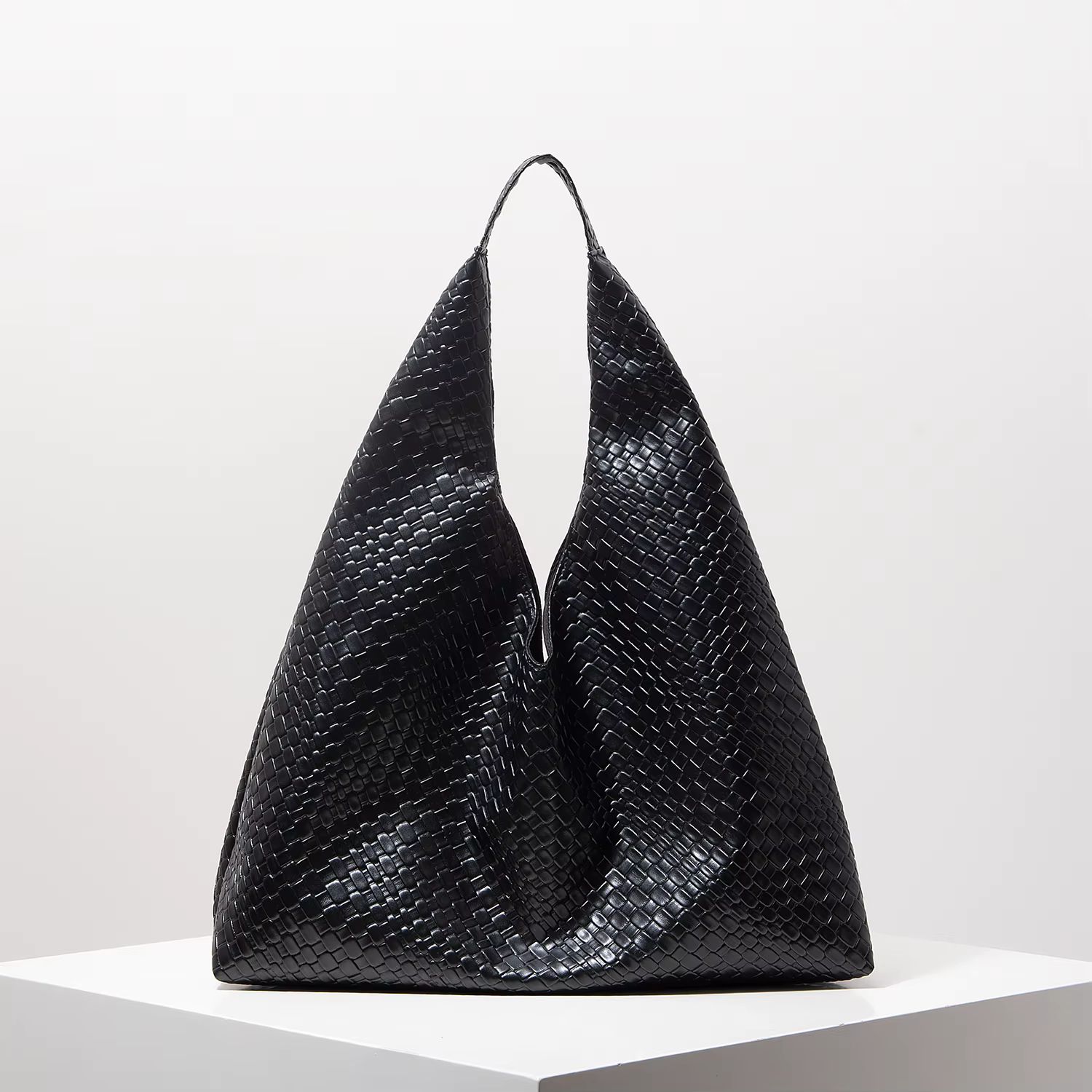Black textured tote bag with loop handles on a white background