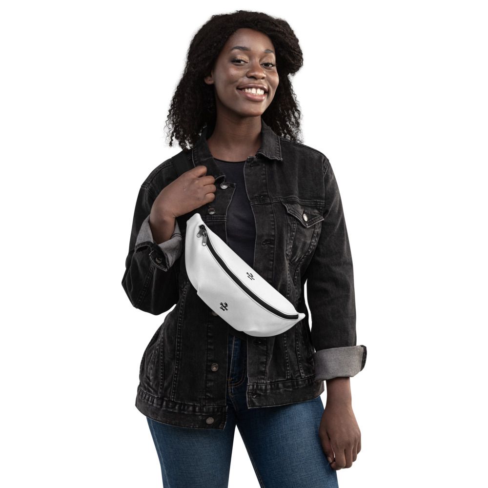 Smiling person wearing a black jacket and white crossbody bag against a white background