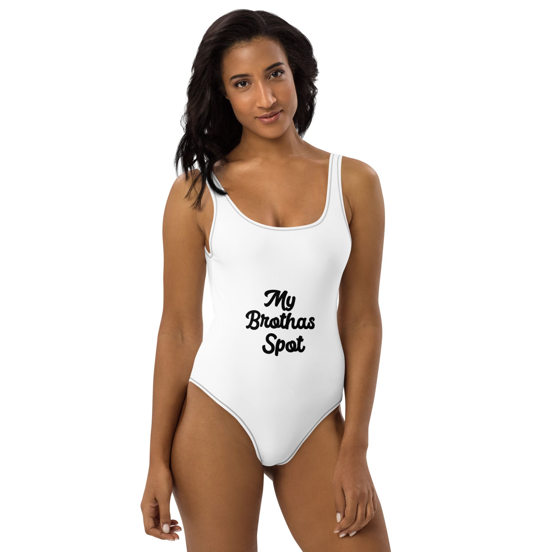 Woman in white one-piece swimsuit with “My Birthday Spot” text, standing against a white background