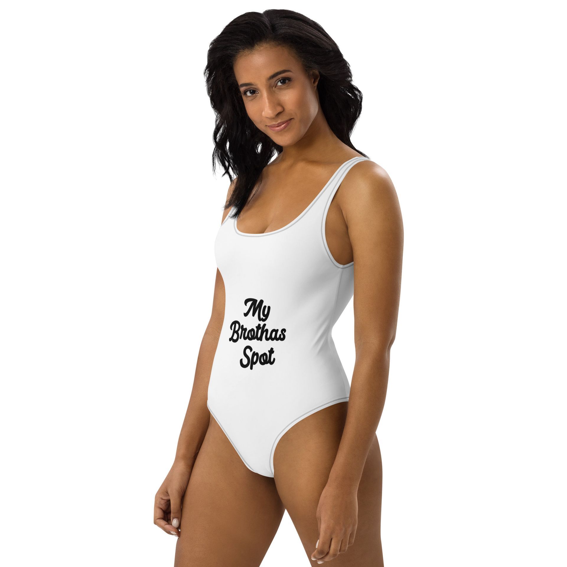 Woman wearing a white one-piece swimsuit with “My Brother’s Spot” text.
