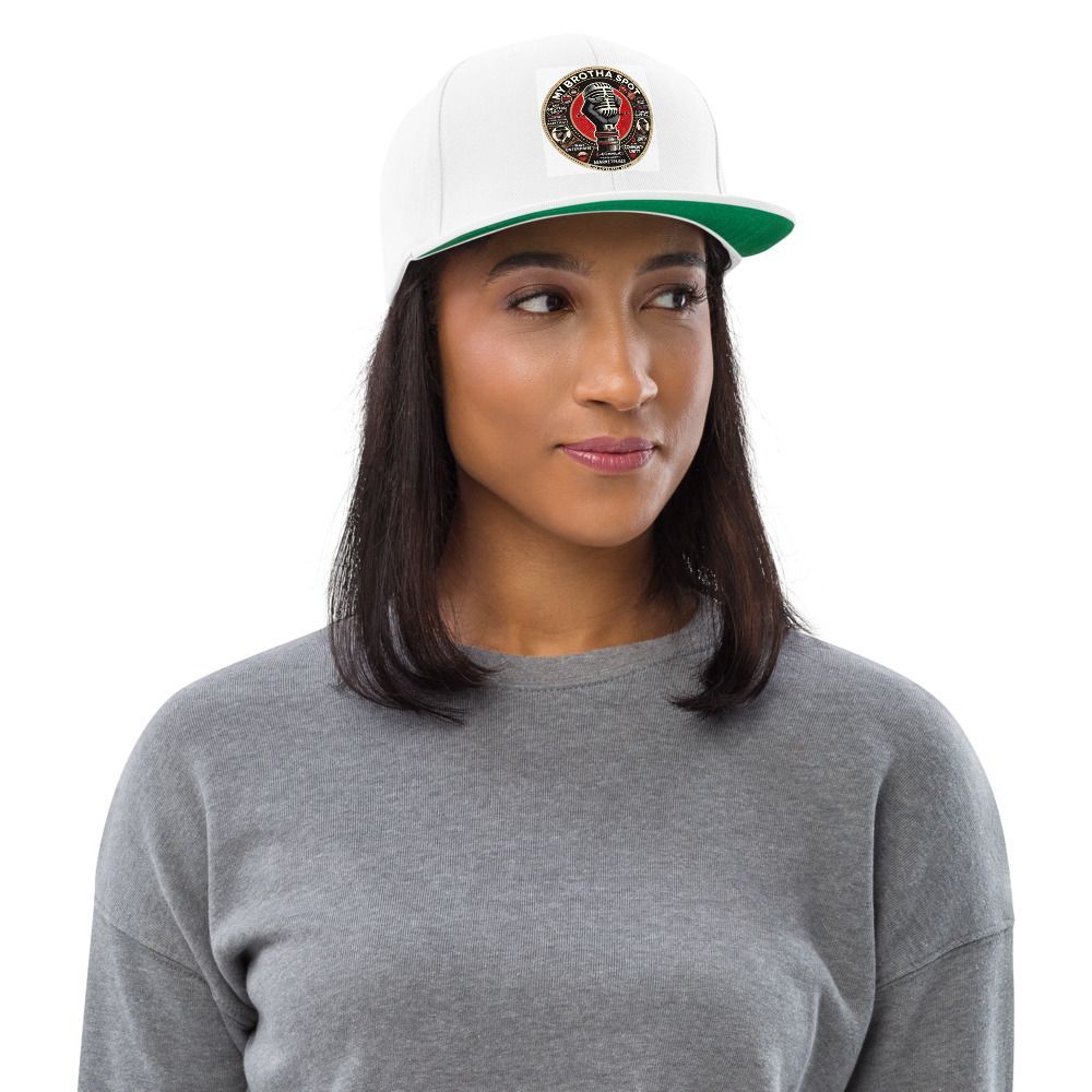 Person wearing a white cap and gray shirt, looking to the side against a white background