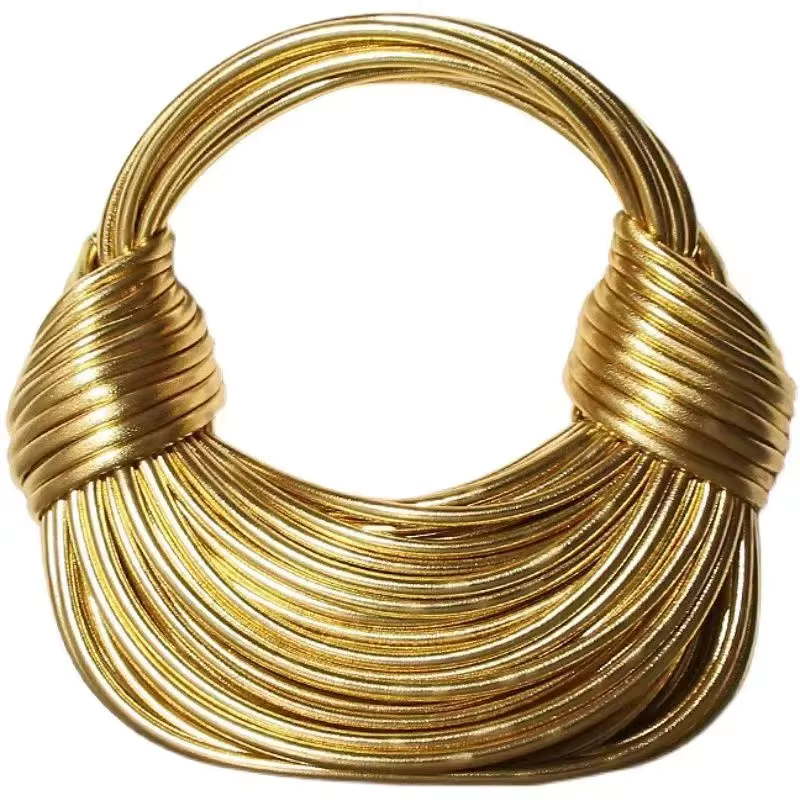 Gold multi-strand wire handbag with rounded handles on a white background
