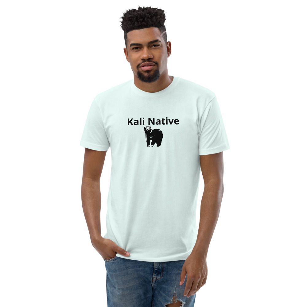 Man wearing a black “Kali Native” T-shirt and blue jeans on a white background