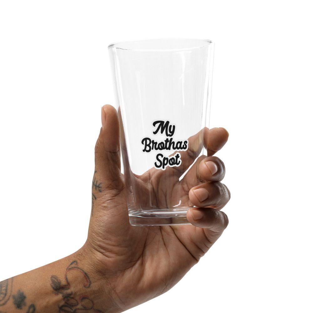 Clear pint glass with “My Brothas Spot” text on a wooden surface