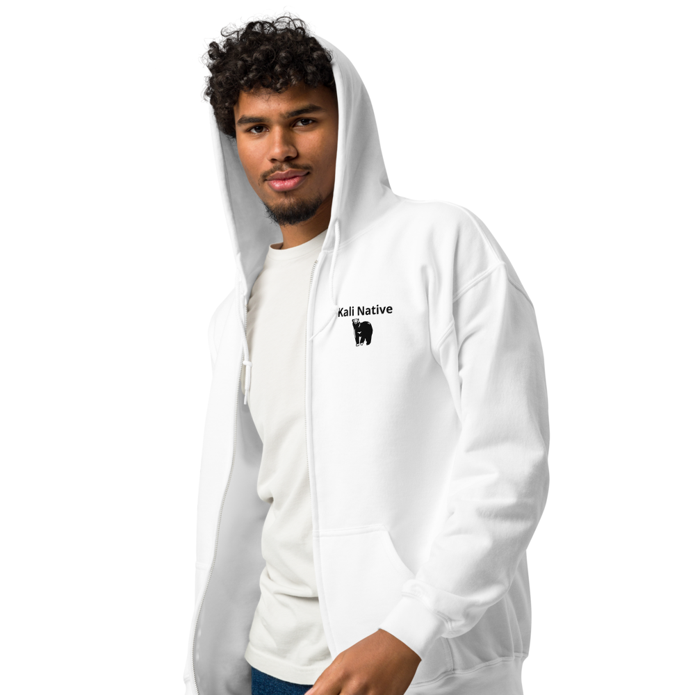 Man in a white hoodie and T-shirt, posing against a plain background.