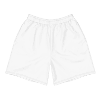 White athletic shorts laid flat on a gray surface with sunglasses, coconut halves, and palm leaves nearby