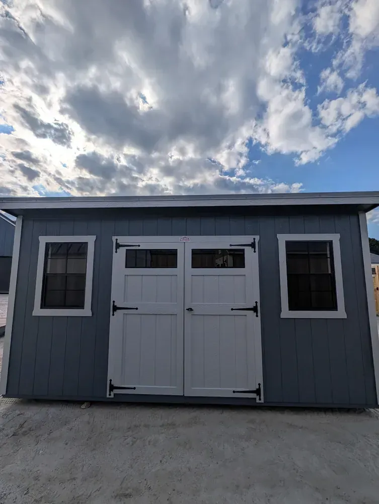 Stor-Mor Cottage storage shed with double doors and windows from Schrocks Repair near Greenwood, SC