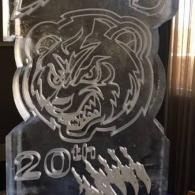 Clear acrylic trophy with a bear logo and “20th” engraved on it.