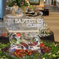 NEA Baptist Clinic ice sculpture centerpiece with flowers and fruit display