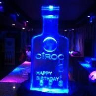 Blue-lit Cîroc bottle-shaped birthday display with “Happy Birthday” text in a dim party setting