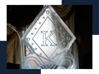 Decorative metal plaque with a large letter K in a diamond frame, with curved scrollwork below