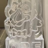 White line-art cartoon duck with a bow tie, etched on a translucent sign or block.