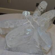 Ice sculptured dragonfly resting on a table top