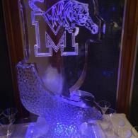 Purple-lit acrylic leopard and large “M” monogram display on a pedestal