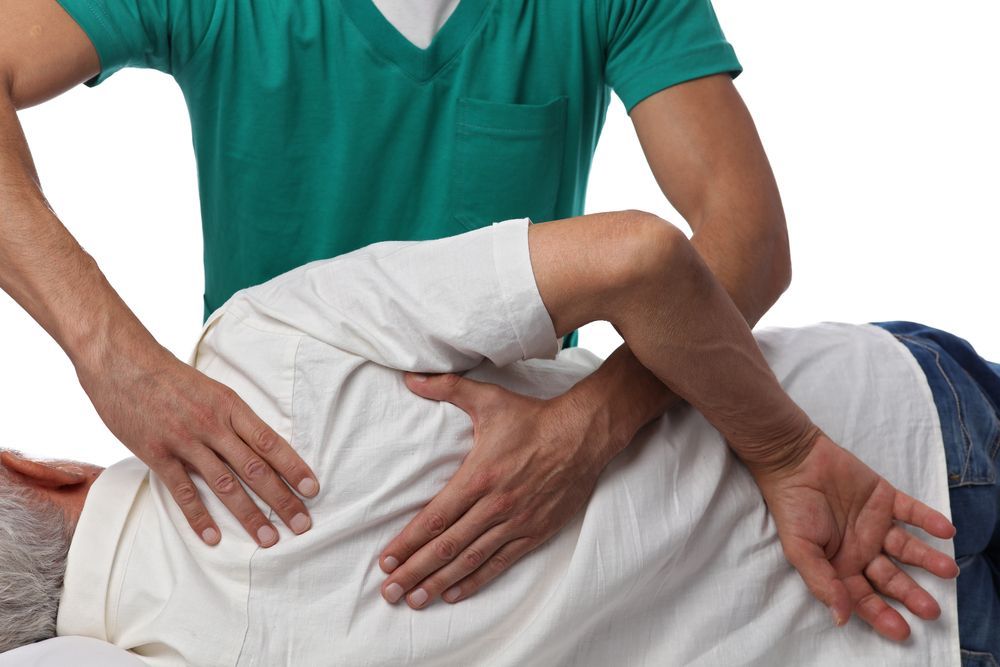 Chiropractor Adjusting a Patient Back — PhysioCare Townsville in Deeragun, QLD