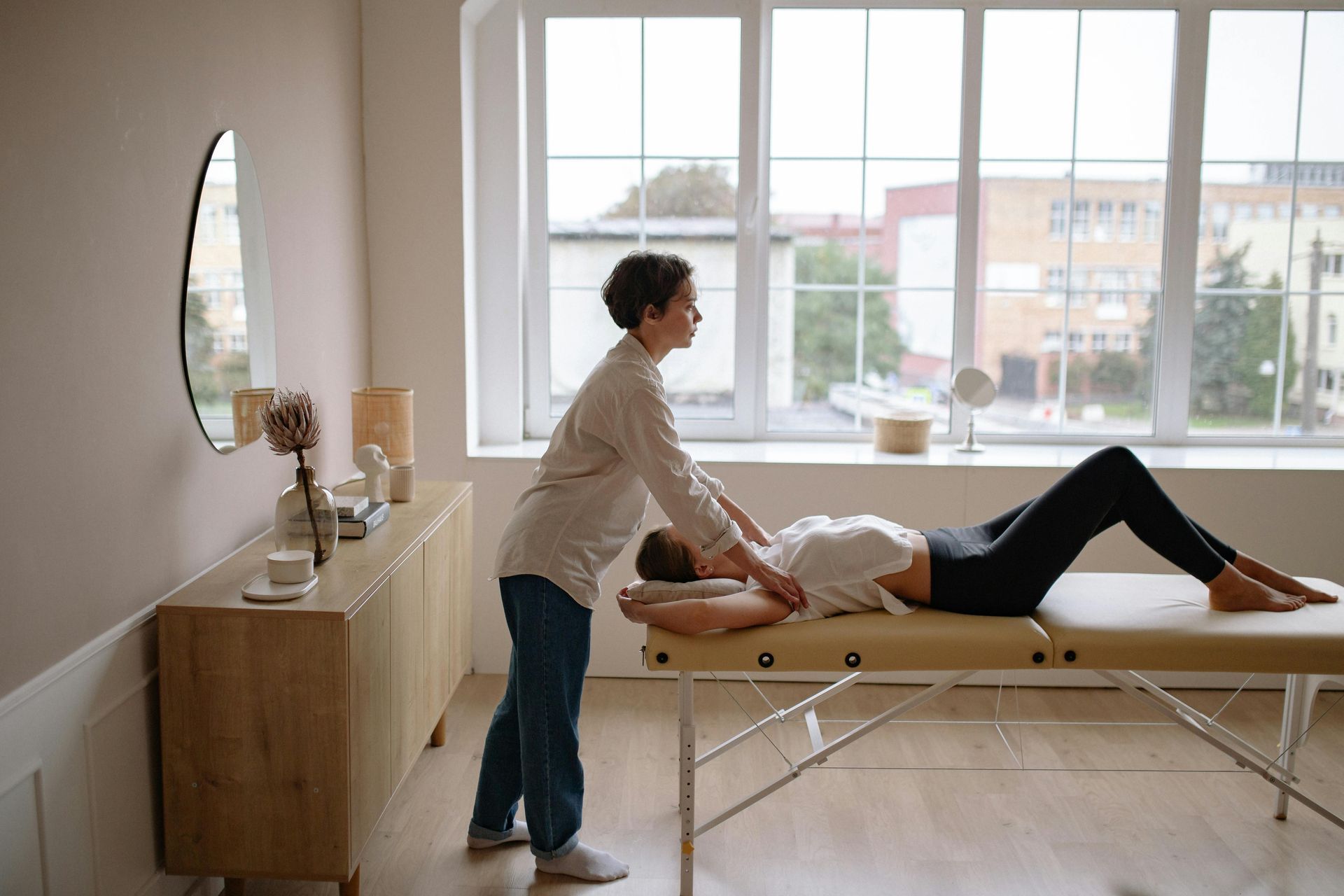 Person Receiving Physical Therapy on a Massage Table — PhysioCare Townsville in Thuringowa Central, QLD