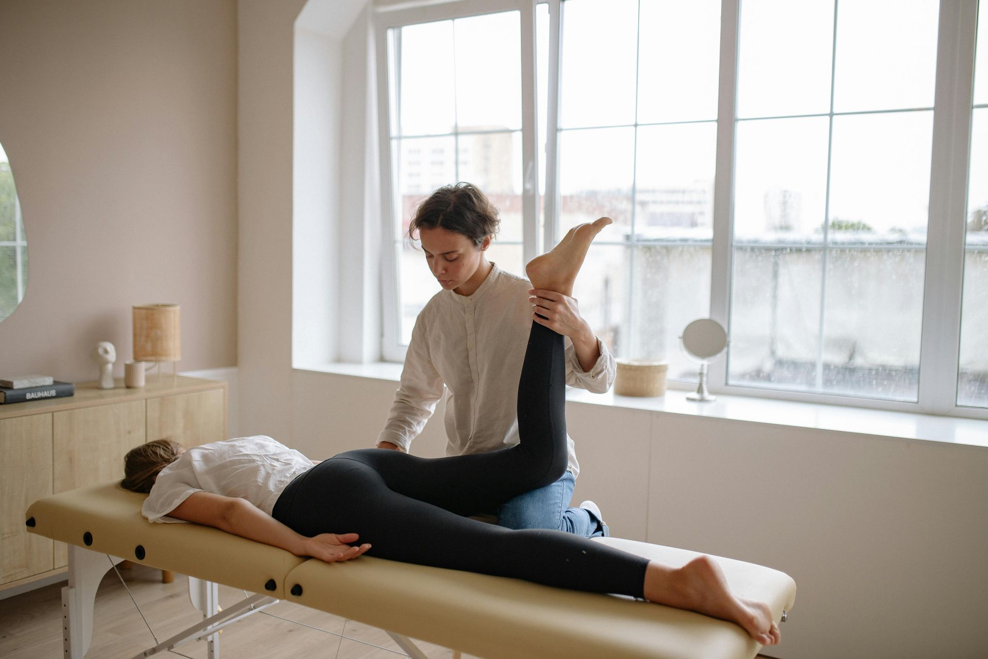Woman Exercising With Resistance Band — PhysioCare Townsville in Thuringowa Central, QLD