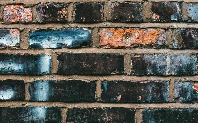 A close up of a brick wall with a lot of bricks.