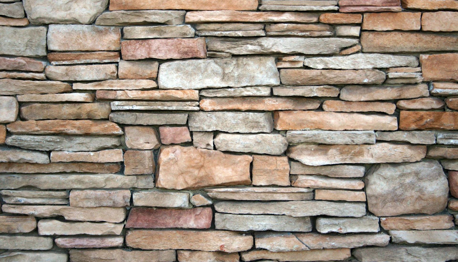A close up of a stone wall made of different types of rocks