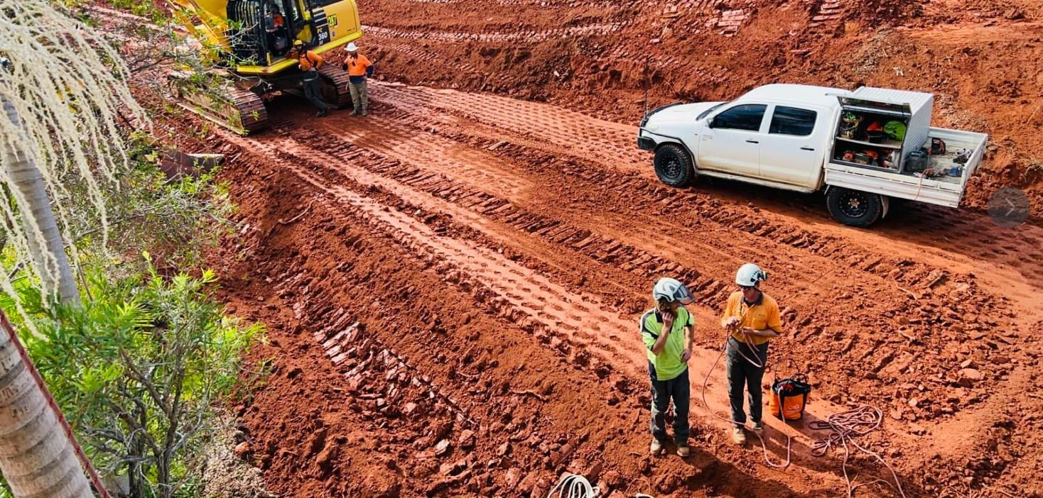 A Couple of Men Standing Next to a Truck on a Dirt Road — All One Arb Tree Service In Bonny Hills, NSW