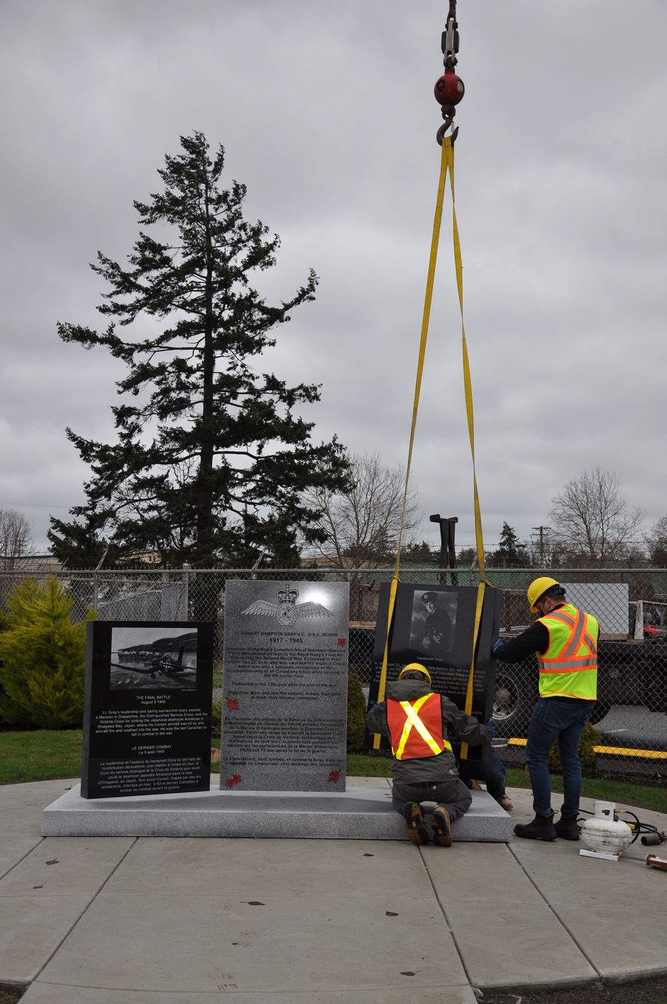 A group of construction workers are working on a monument