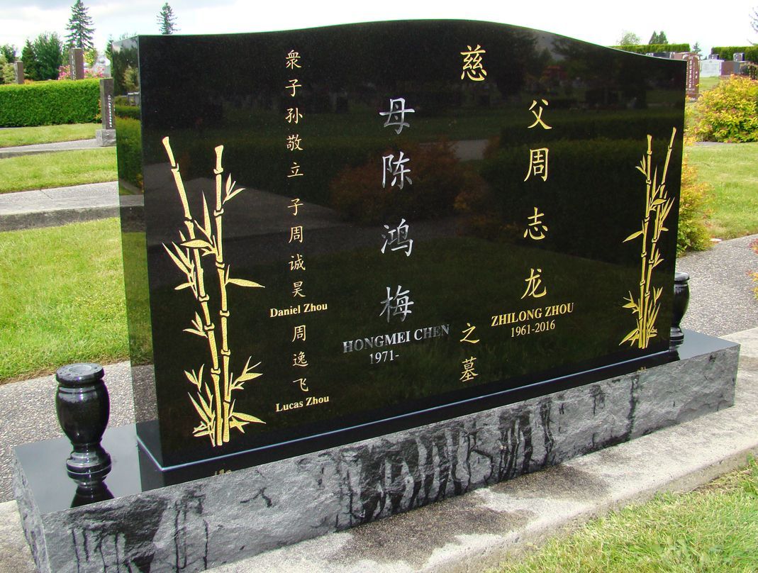 a black gravestone with chinese writing on it