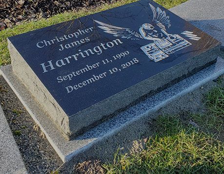 A black gravestone with the name christopher james harrington on it