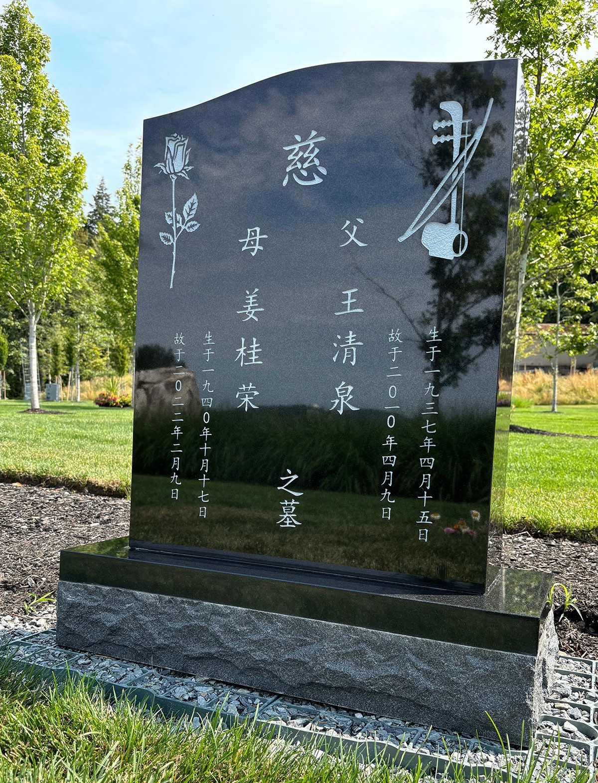 All polished ebony black granite upright headstone on matching base with 2