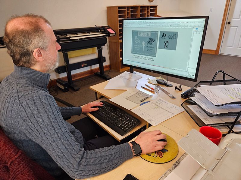 A man is sitting at a desk working on a computer