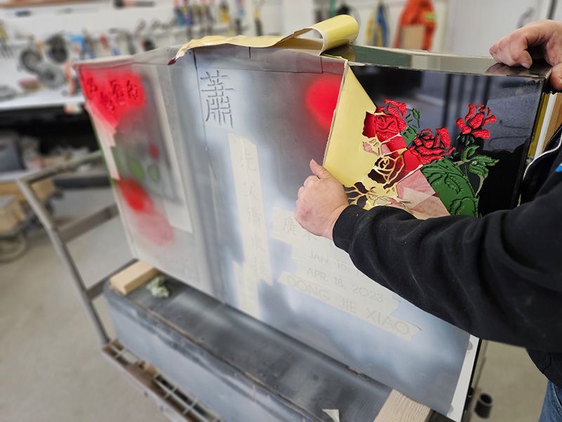 A person is holding a piece of paper with a picture of roses on it.