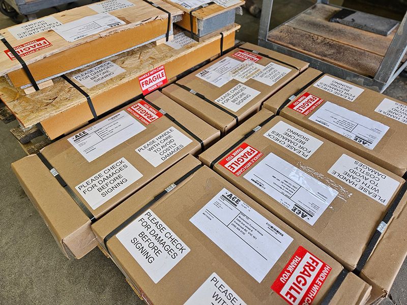 A bunch of boxes with fragile stickers on them