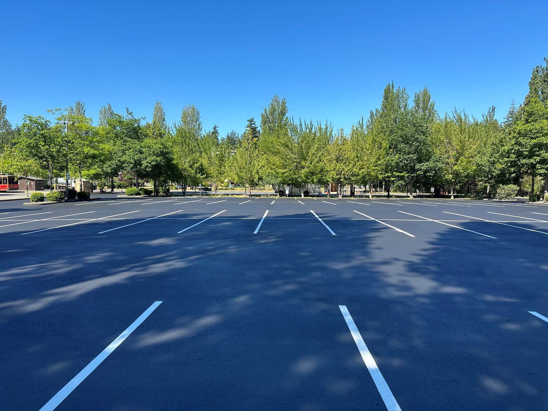 An empty parking garage with yellow and black stripes on the pillars