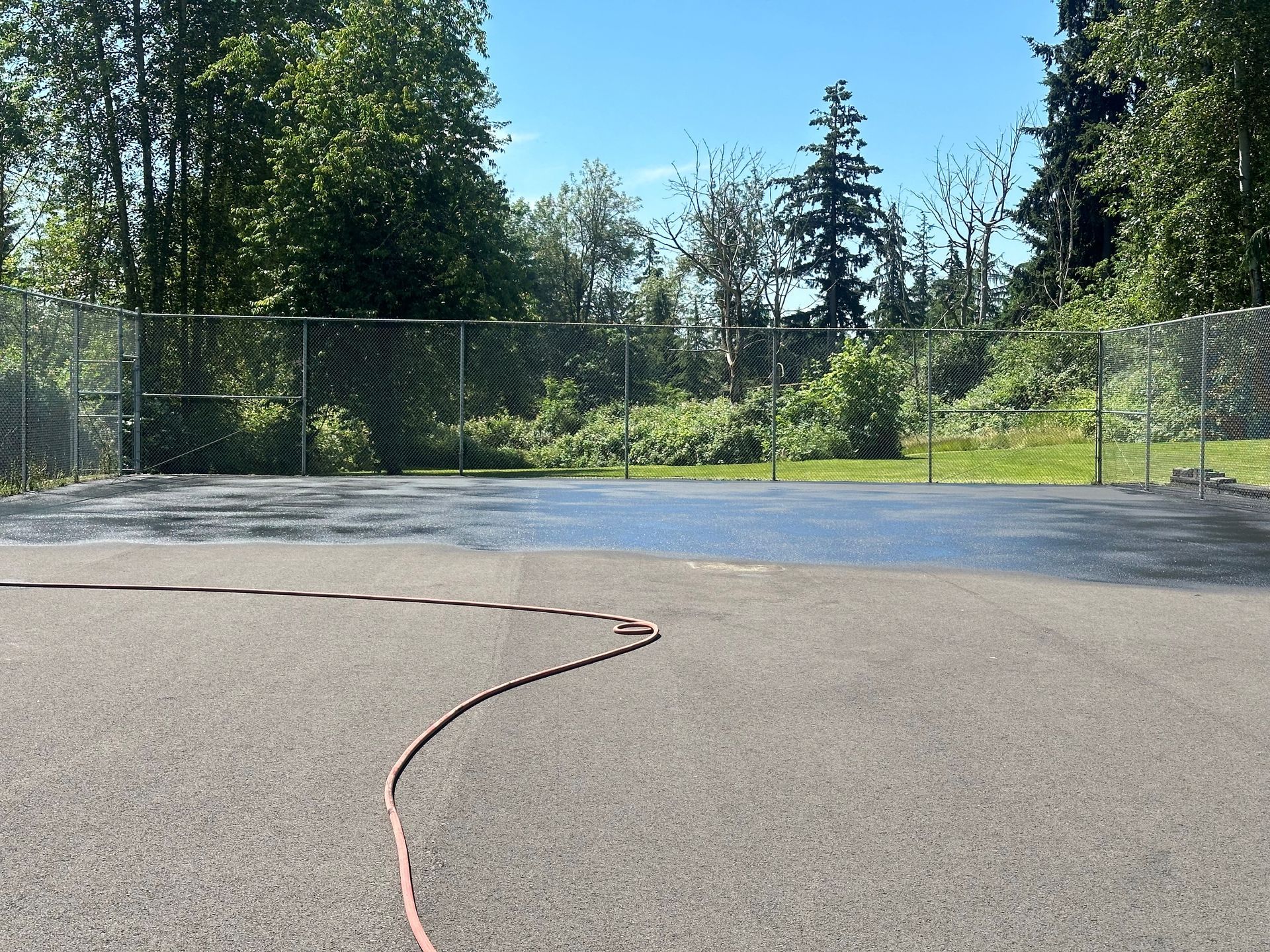 A group of people are spreading asphalt on a road.