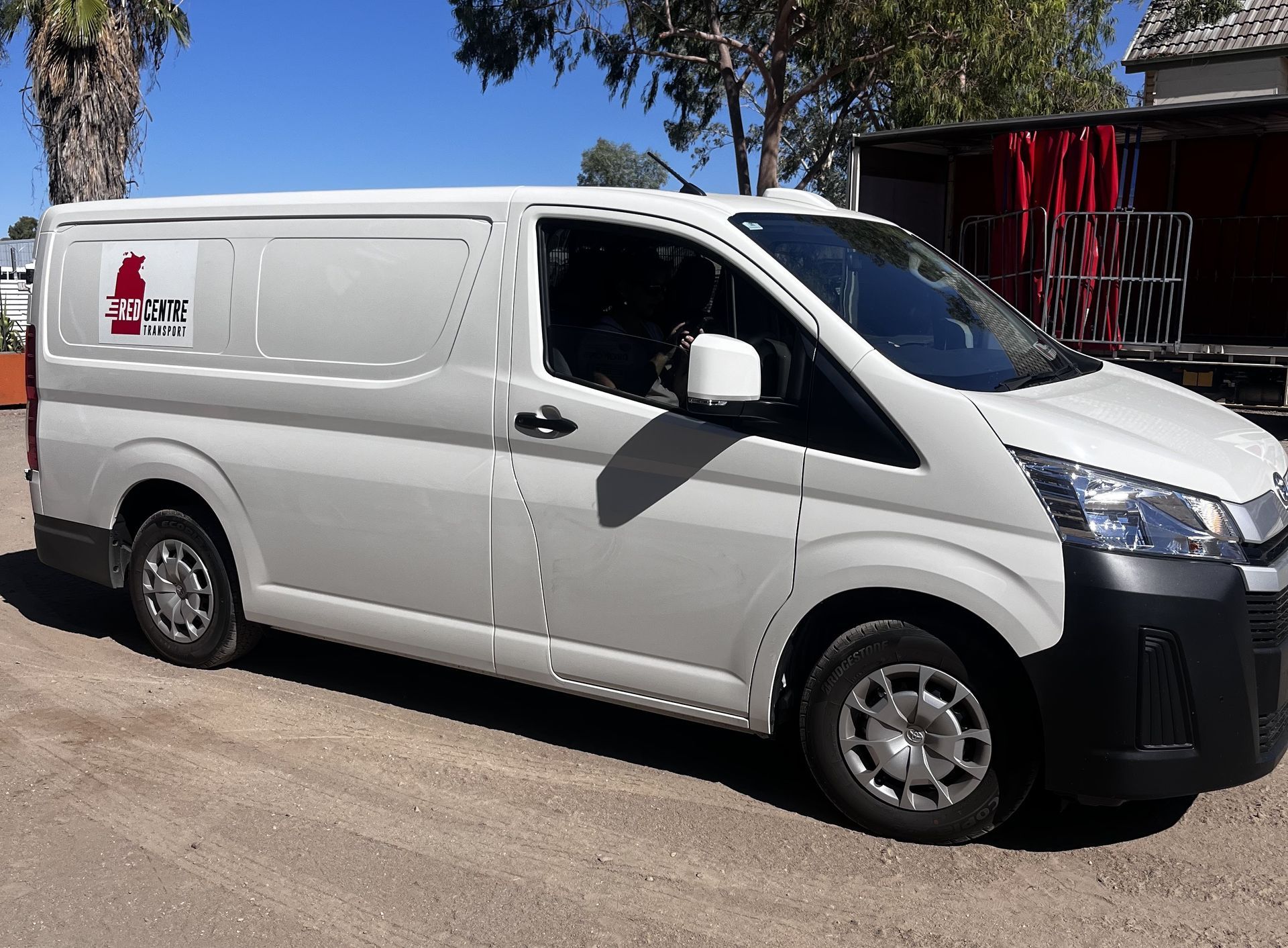 Three White Delivery Vans Parked in Front โ Red Centre Transport in Braitling, NT