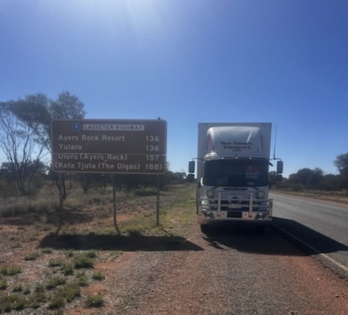 Two Workers in Blue Uniforms Load Boxes Into a White Van — Red Centre Transport in Braitling, NT