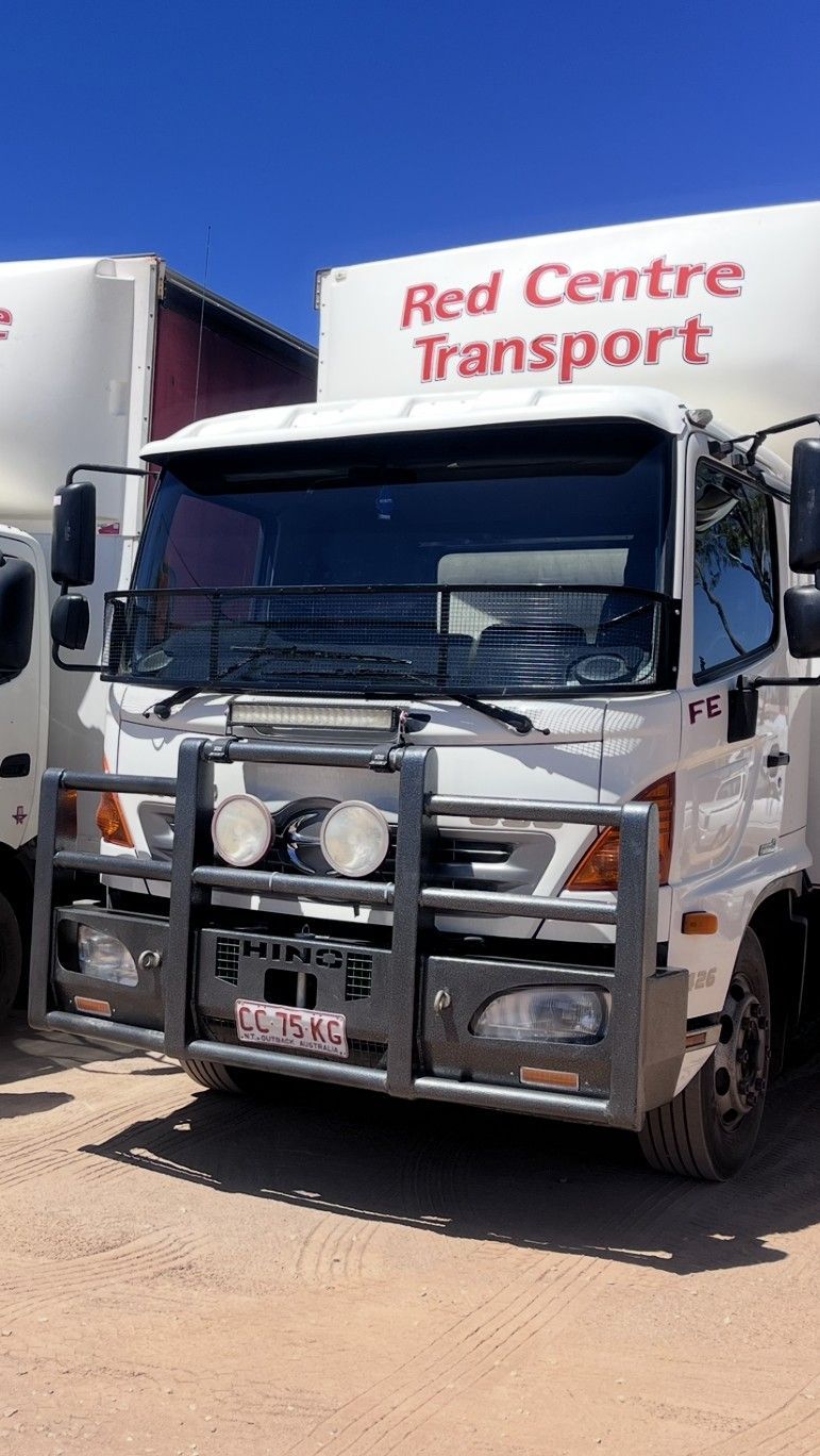 White Semi-truck With an Empty Flatbed Trailer on a Highway โ Red Centre Transport in Braitling, NT