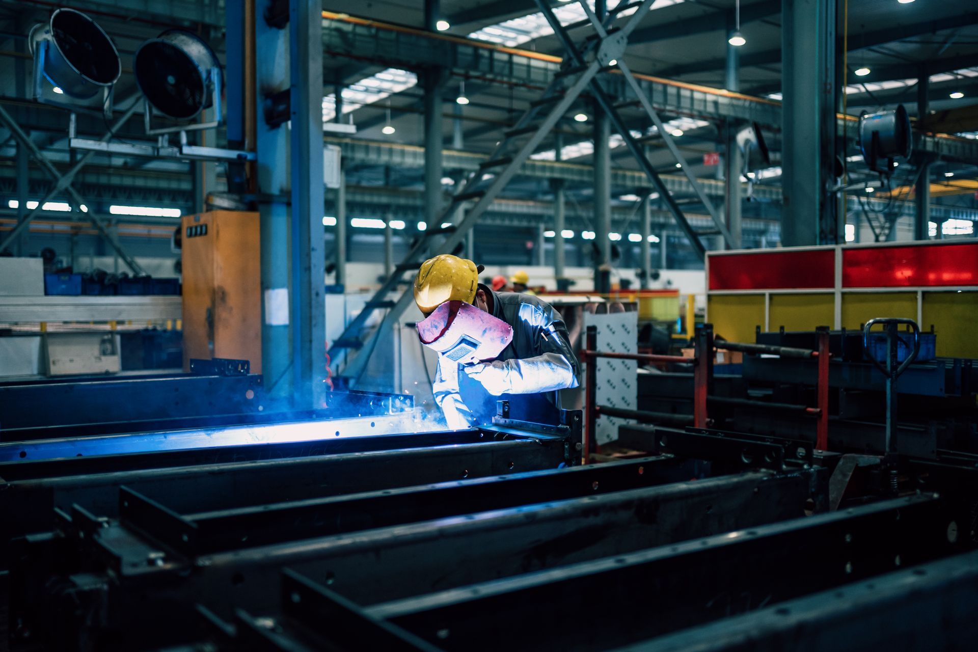 A young man is working in a factory workshop alone, mending an ornamental steel structure. A young man is working in a factory workshop alone, mending an ornamental steel structure.