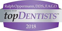 Top Dentists 2018 award badge for Ralph Oppermann, DDS, F.A.G.D., in purple and silver